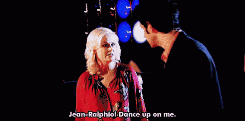a man and a woman are dancing and the man is saying jean-ralphio dance up on me