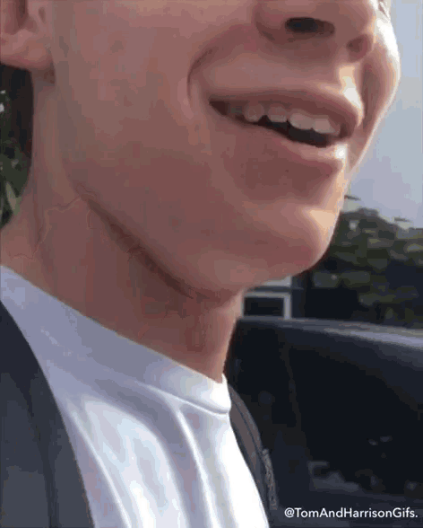 a close up of a person 's mouth with the words tom and harrison gifs written on the bottom