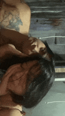 a man and a woman are laying next to each other in a room