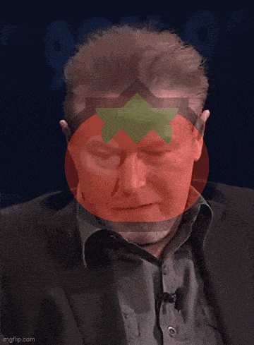 a man in a suit has a tomato on his head