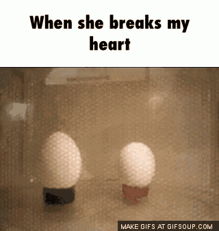 two eggs in a glass container with the words " when she breaks my heart " above them