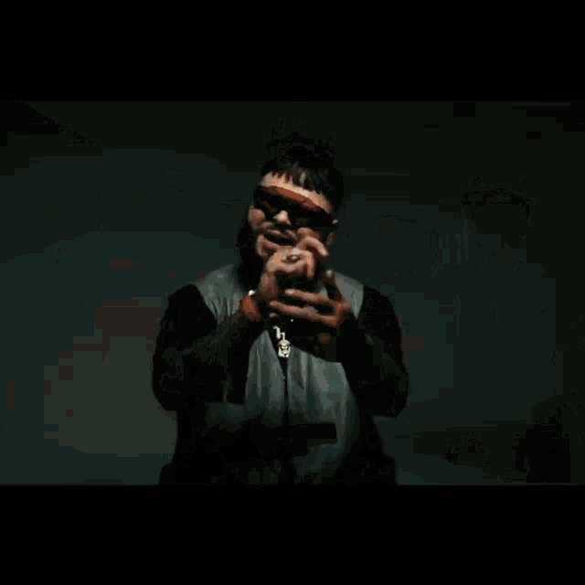 a man with a beard and goggles is holding a gun in his hand