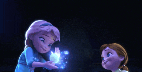elsa and anna are standing next to each other in a dark room holding a blue object .