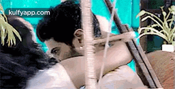 a man and a woman are hugging each other in a pool .