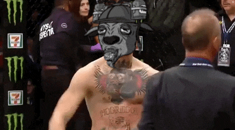 a man with a tattoo of a dog on his chest is standing in a boxing ring .