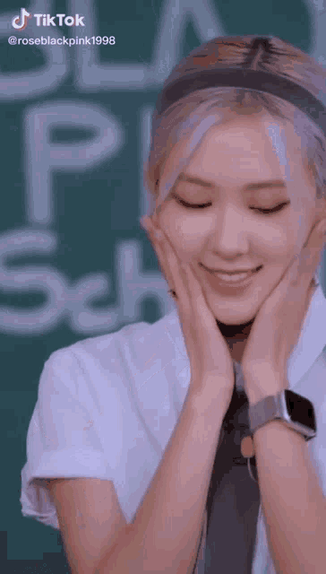 a girl wearing a watch and a headband is smiling