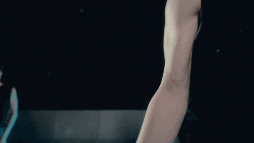 a close up of a person 's arm with a light behind it .