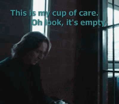 a man sitting in front of a window with the words " this is my cup of care " above him