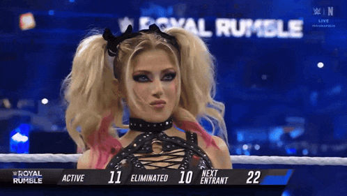 a woman in a wrestling ring with the words royal rumble on the screen
