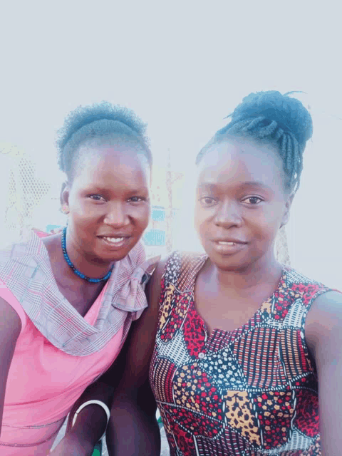 two women posing for a picture with one wearing a leopard print top