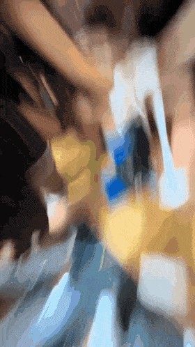 a blurry picture of a person holding a bottle with a blue label