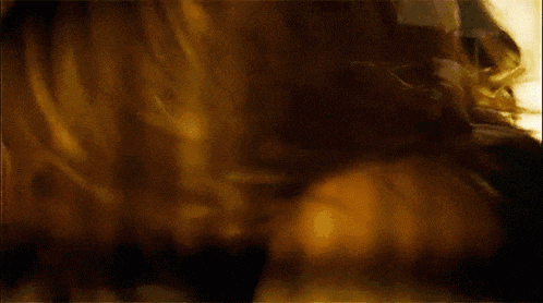 a close up of a woman 's face and neck with a man holding her breast .