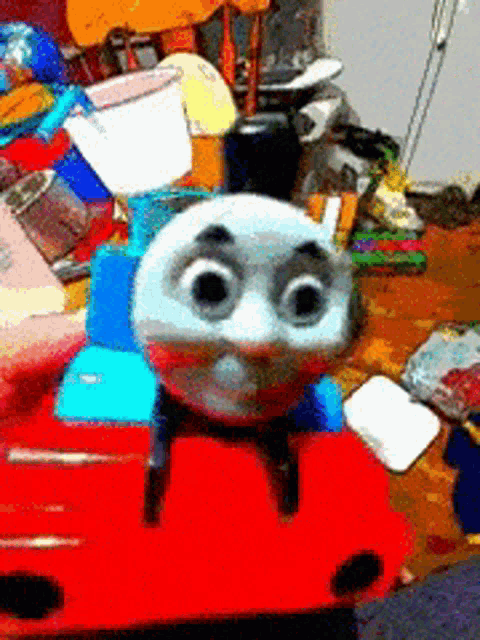 a thomas the train toy is sitting on top of a red table