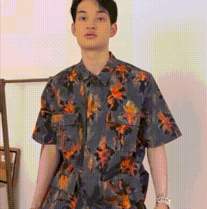 a man is wearing a floral shirt and a watch .