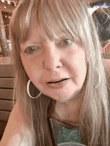 a close up of a woman 's face with muglife.com written on the bottom right