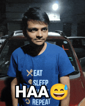 a man wearing a blue t-shirt that says eat sleep haa repeat