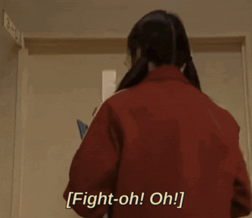 a woman in a red jacket is saying fight-oh! oh!