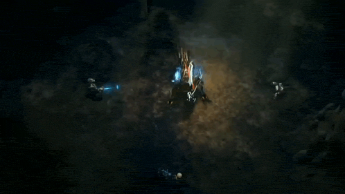 a group of people are fighting a monster in a video game in a cave .