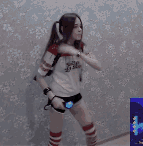 a woman in a harley quinn costume is dancing