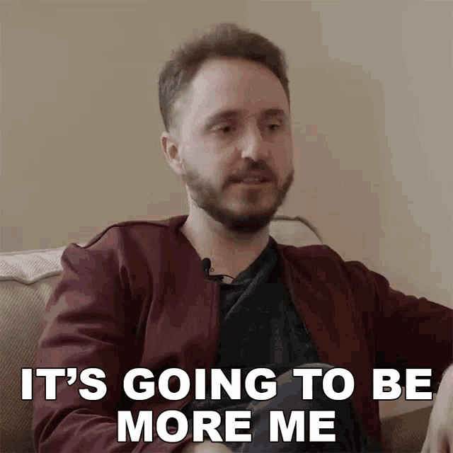 a man sitting on a couch with the words it 's going to be more me