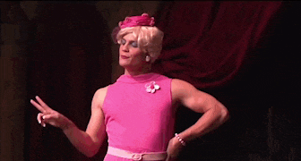 a woman in a pink dress stands on a stage next to a group of girls and says no alcohol on the bottom