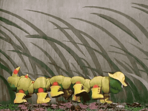 a green and yellow caterpillar wearing yellow rain boots and a yellow hat