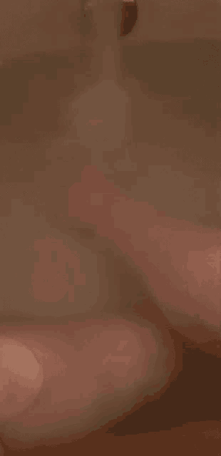 a blurry picture of a person taking a bath .