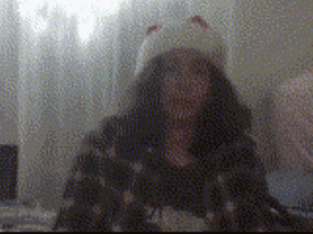 a blurry picture of a woman wearing a hat with ears