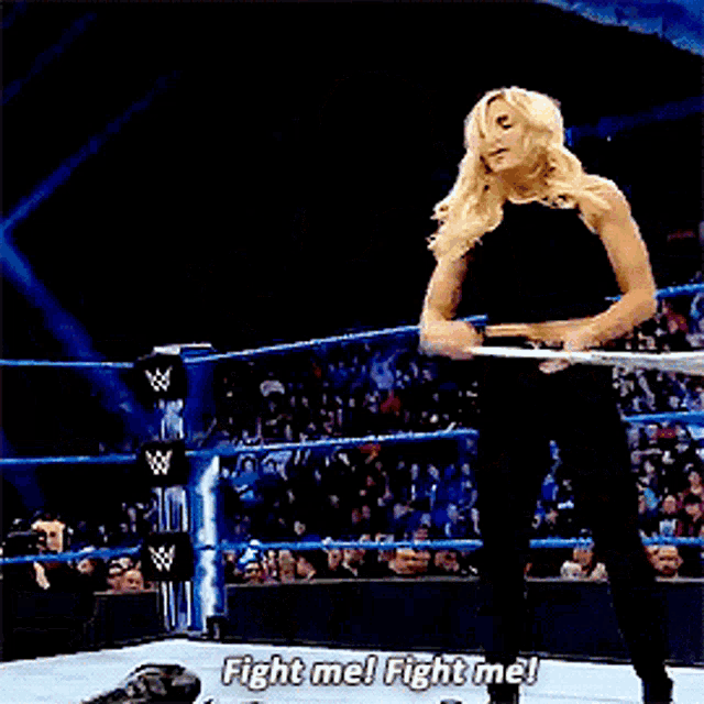 a woman in a boxing ring says fight me