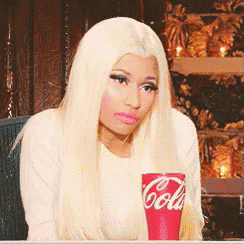 a blonde woman is holding a coca cola cup in her hand
