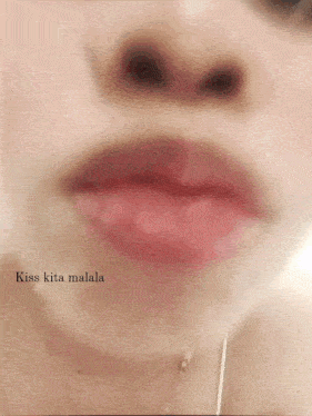 a close up of a woman 's lips with the words kiss kita malala below