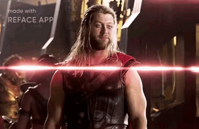 thor is standing in front of a red light and looking at the camera .