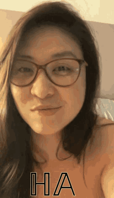 a close up of a woman wearing glasses with the word ha on the bottom right
