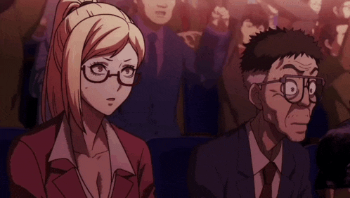 a man and a woman in glasses are sitting in a crowd of people