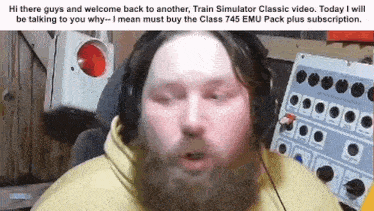 a man with a beard wearing headphones and a yellow shirt is talking to someone