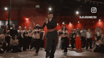 a group of people are dancing in a dance studio with jojogomezxo written on the bottom