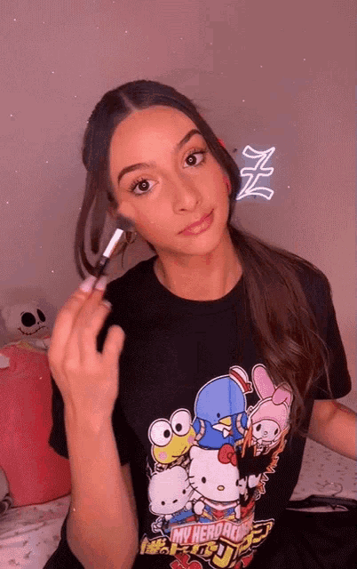 a woman wearing a hello kitty t-shirt is applying makeup