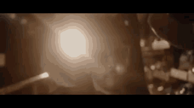 a close up of a person 's face in a dark room with a light shining through the window .