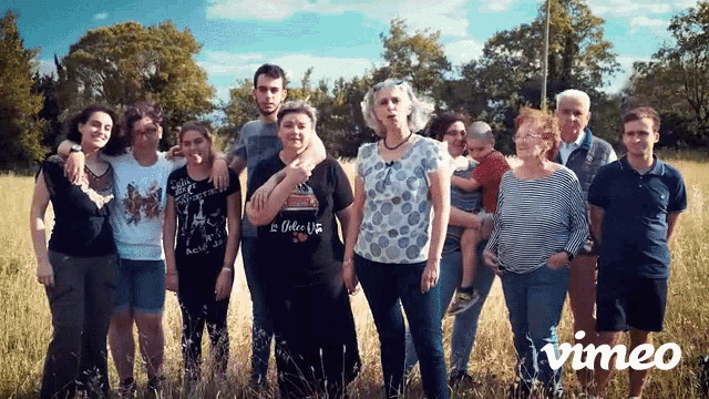 a group of people are standing in a field with vimeo written on the bottom