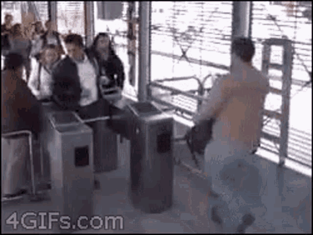 a man is standing in front of a crowd of people at a train station .