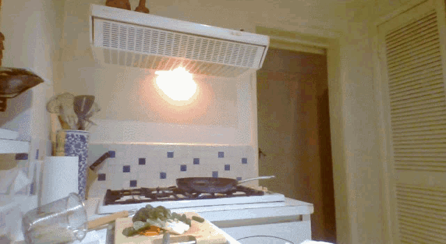 a kitchen with a stove top oven and a light on