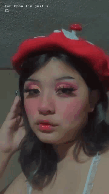 a girl wearing a red beret with a mushroom on it