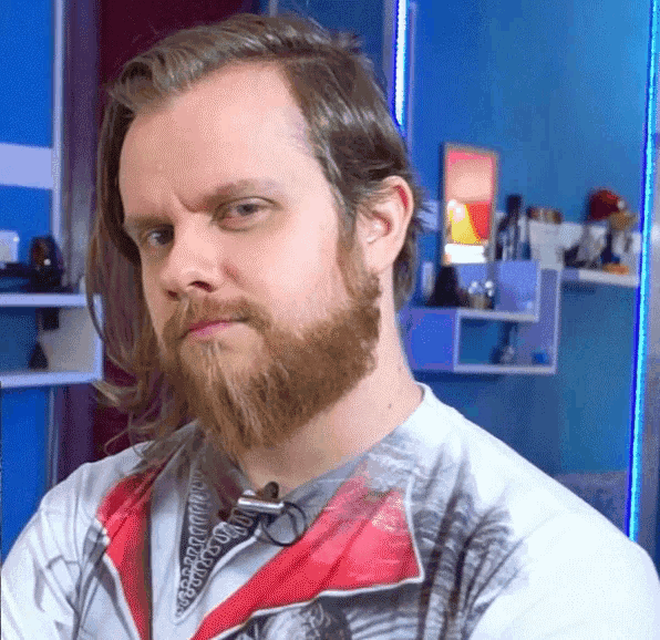 a man with long hair and a beard is wearing a white shirt with a palm tree on it