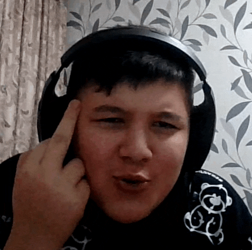 a young man wearing headphones is making a face