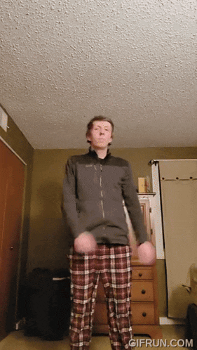 a man in plaid pants is dancing in a room with gifrun.com written on the bottom of the screen
