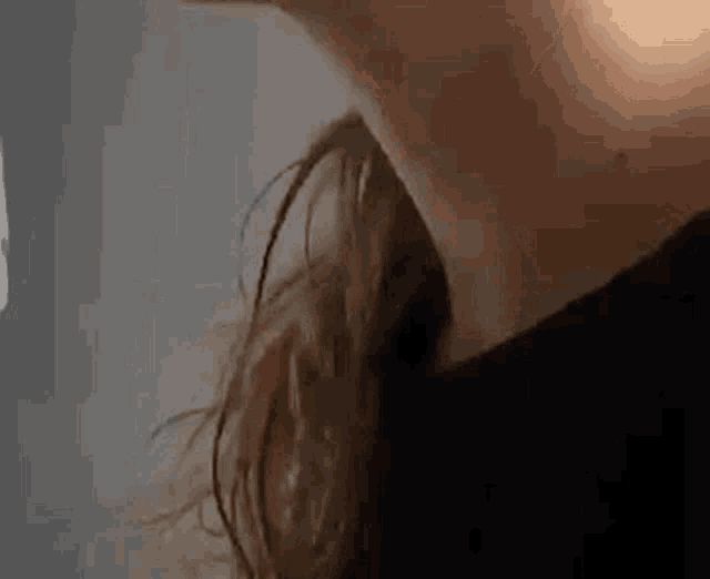 a close up of a person 's neck and hair