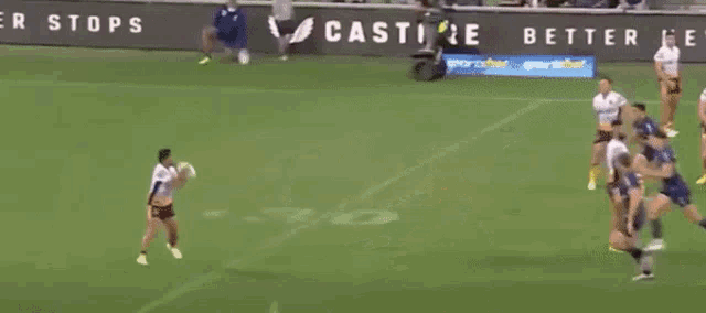 a rugby game is being played in front of a banner that says " castre better nev "