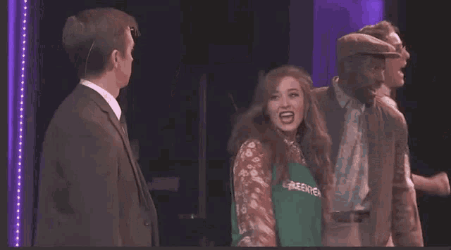 a woman wearing a green apron with the word green tea on it