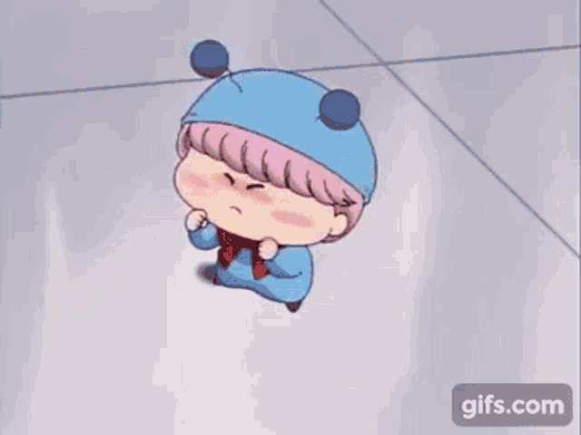 a cartoon character wearing a blue hat and scarf is standing on the floor .