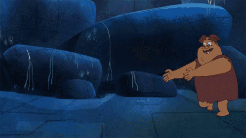 a cartoon character is standing in a cave with a skull on his head